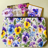 victorian pansy themed letterbox gift set with floral pouch, botanical stickers, vellum journaling sheets and antique style metal and glass bookmark in shades of purple, yellow and blue