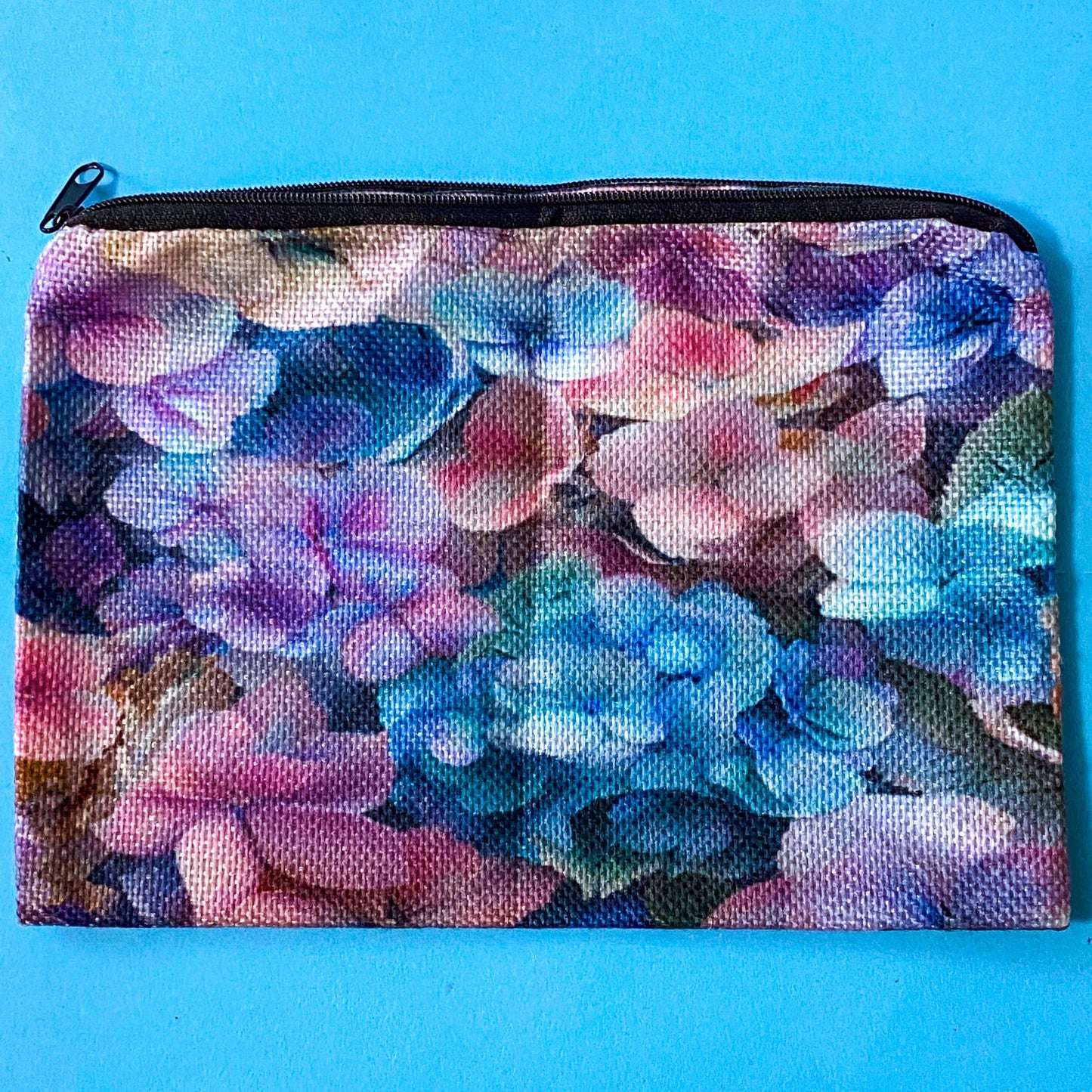 hydrangea whispers midi letterbox gift set with a textured hydrangea pouch, floral ballpoint pen, blank greetings card with kraft envelope, two hydrangeas postcards and an adjustable crystal floral bracelet in a lilac drawstring bag. uk gifts shop.