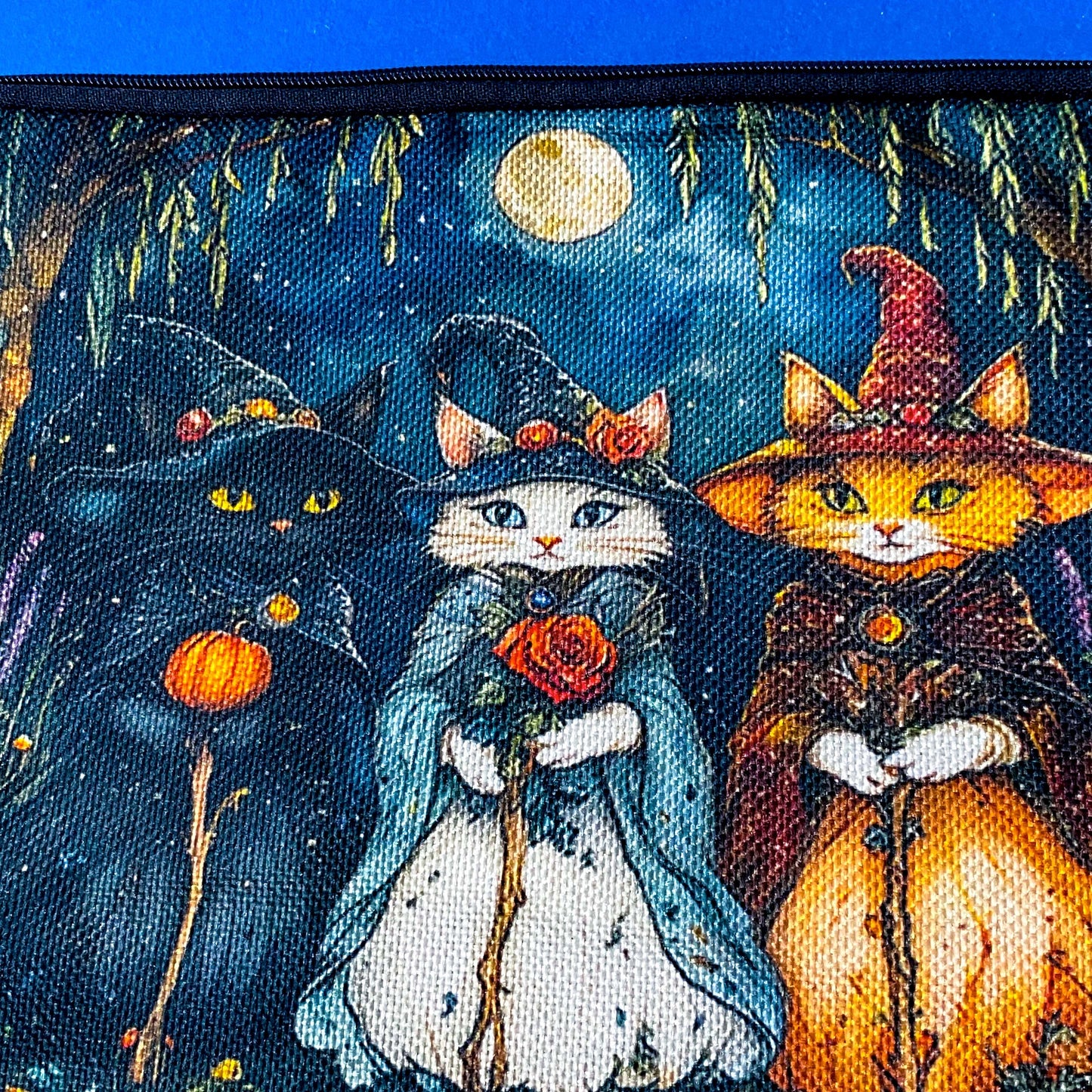 textured canvas pouch featuring three witch cats gathering beneath a full moon in an enchanted woodland with willow branches, mushrooms and autumn leaves. Dark blue, green, storm grey and black. Uk letterbox gifts. Halloween theme.