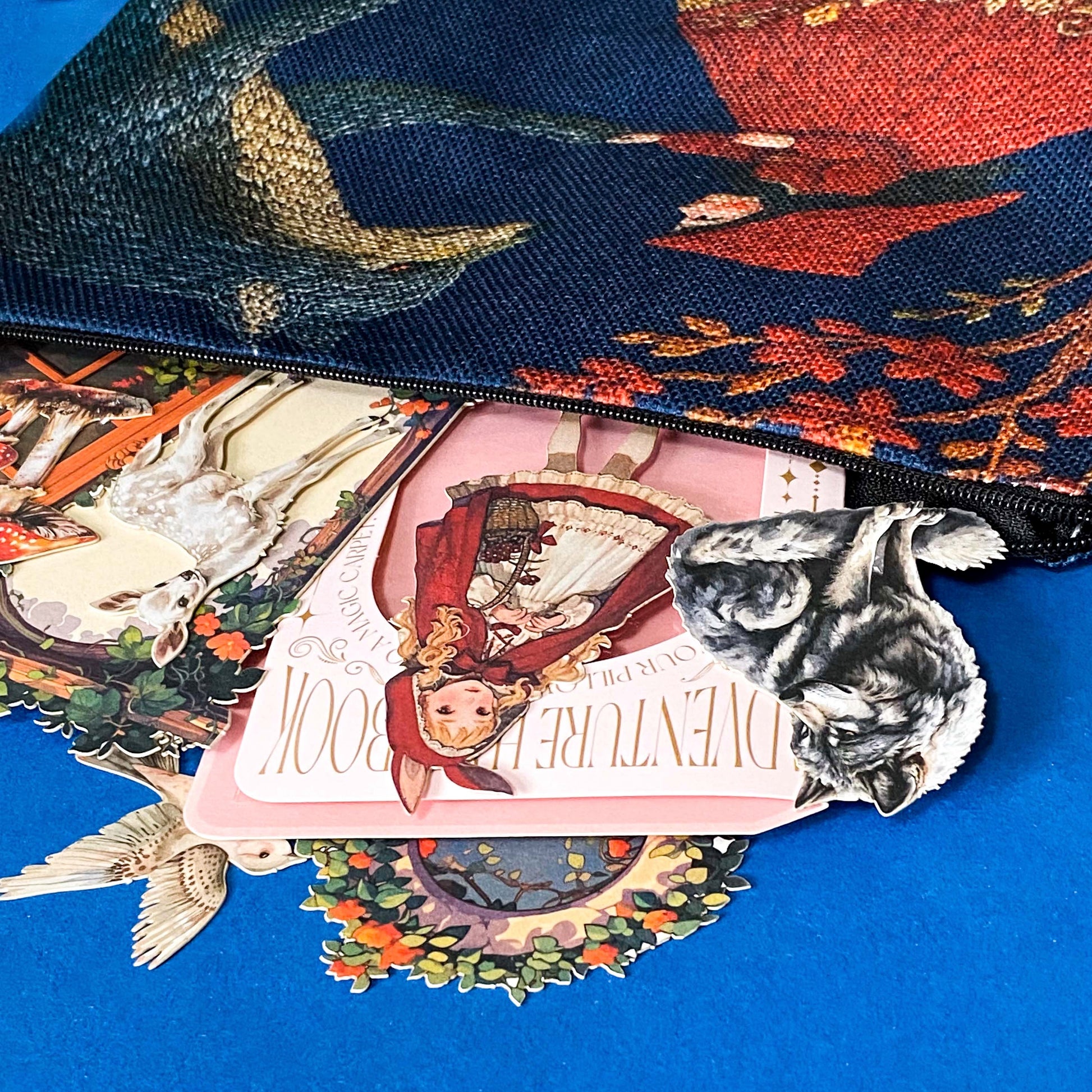 close up of the little red riding hood gift set with open canvas pouch and stickers