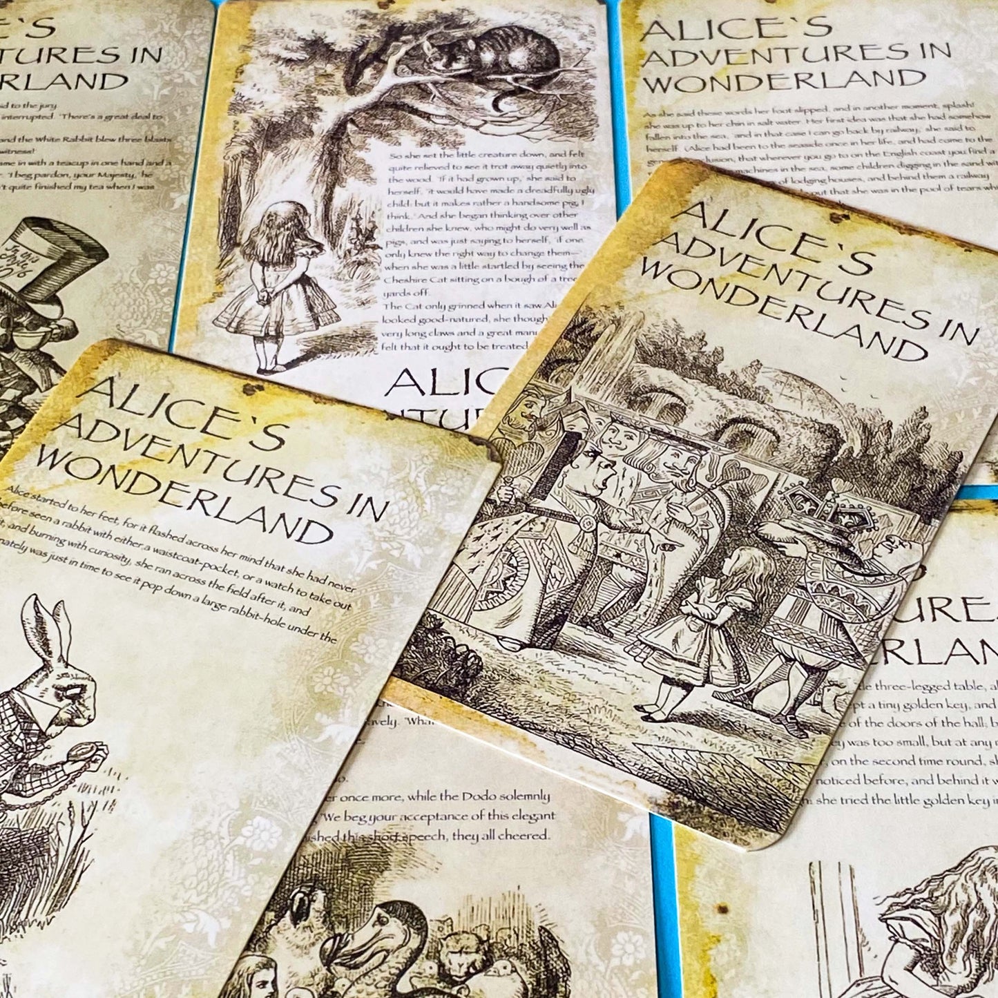 vintage alice in wonderland postcard set with aged sepia parchment illustrations, kraft belly band and wax seal presentation making a beautiful uk letterbox gift