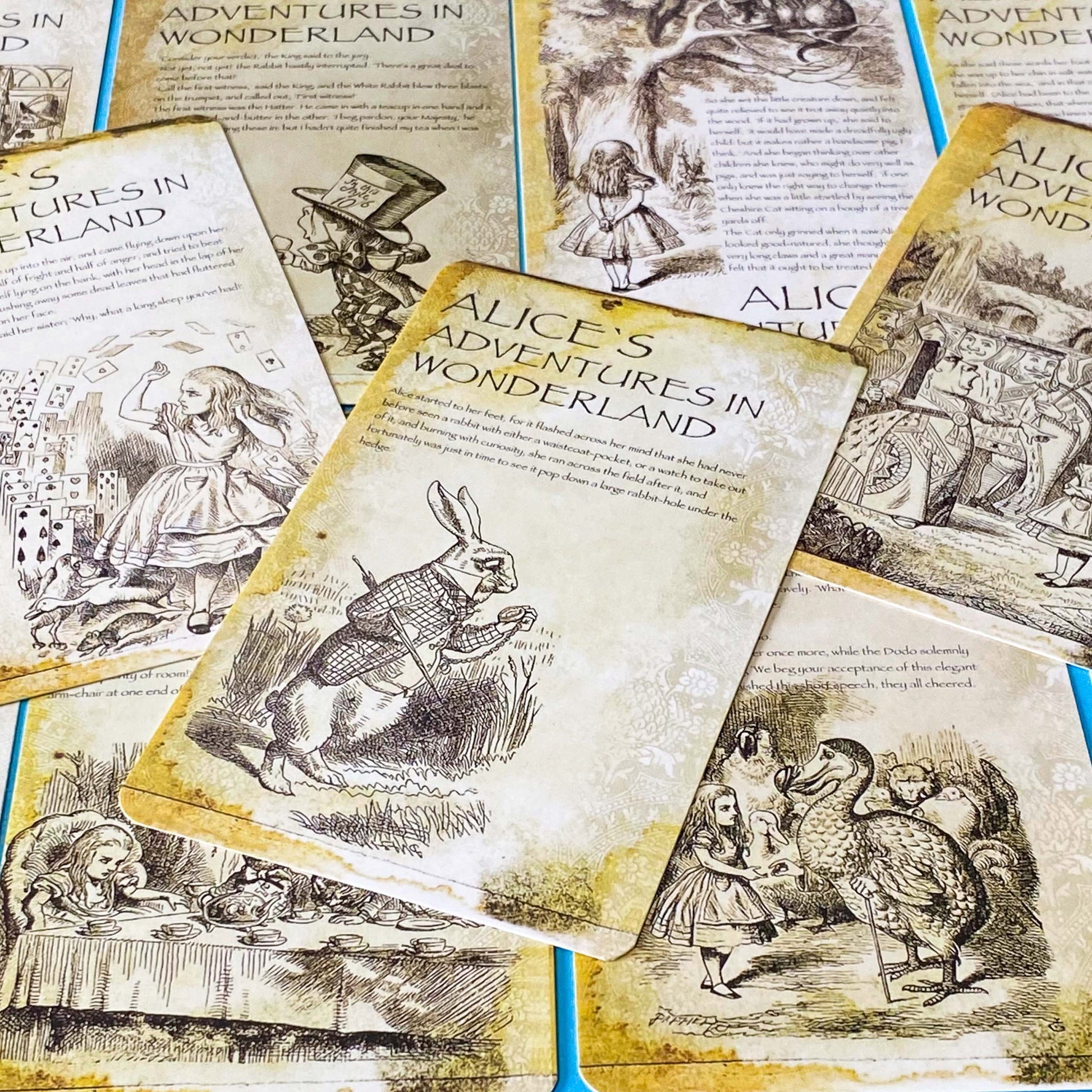 vintage alice in wonderland postcard set with aged sepia parchment illustrations, kraft belly band and wax seal presentation making a beautiful uk letterbox gift