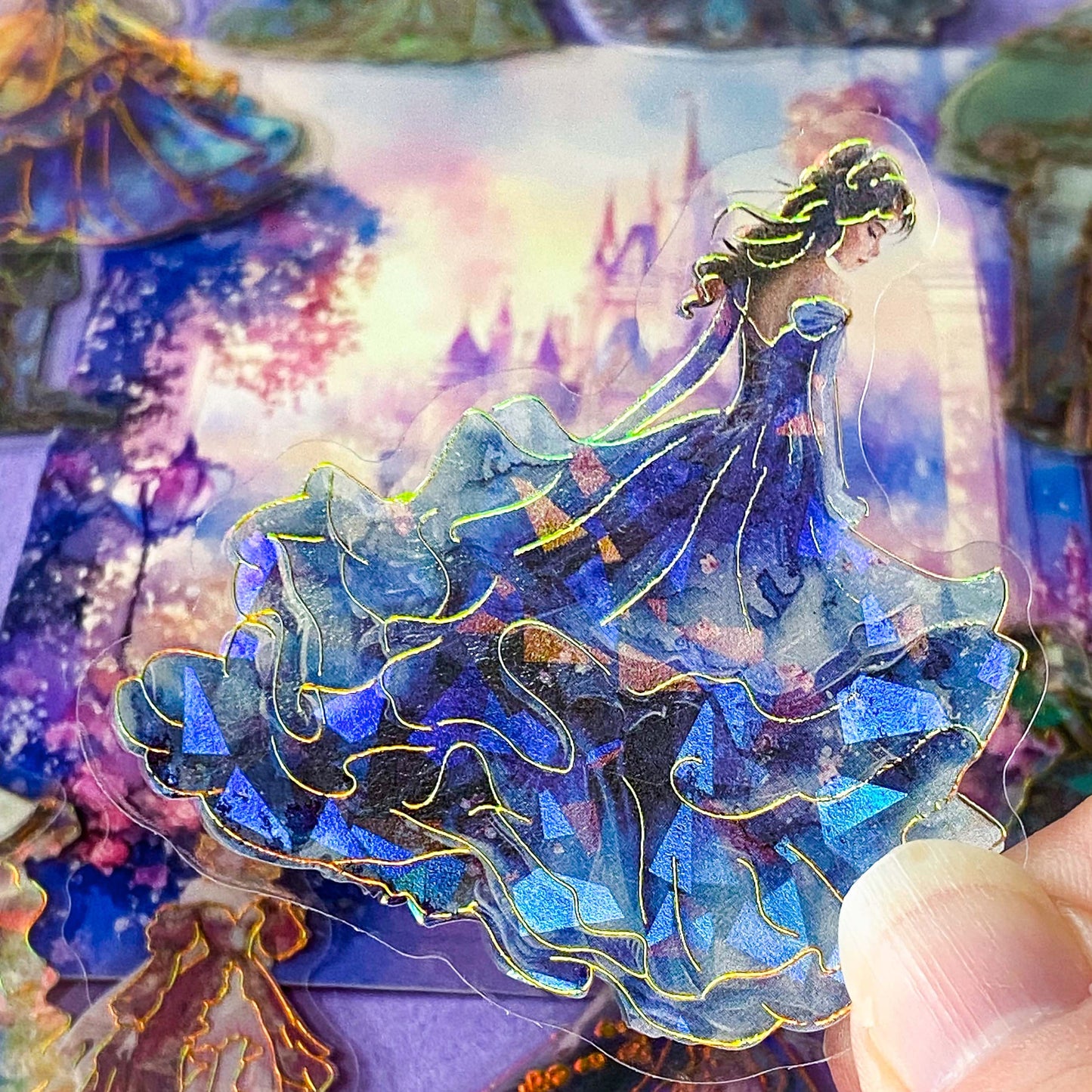 pack of 30 holographic princess stickers with gold foil outlines featuring elegant dancing princesses, castle scenes and fantasy ball gowns on transparent pet plastic clear material. uk cute stationery shop. storybook sticker set.