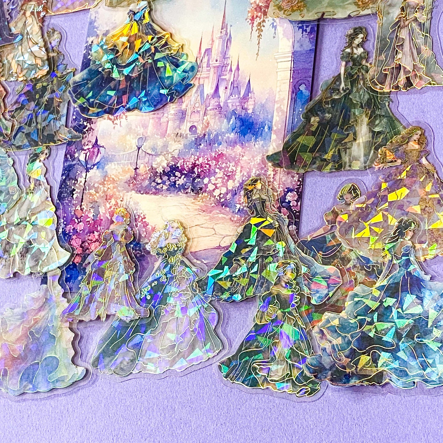pack of 30 holographic princess stickers with gold foil outlines featuring elegant dancing princesses, castle scenes and fantasy ball gowns on transparent pet plastic clear material. uk cute stationery shop. storybook sticker set.