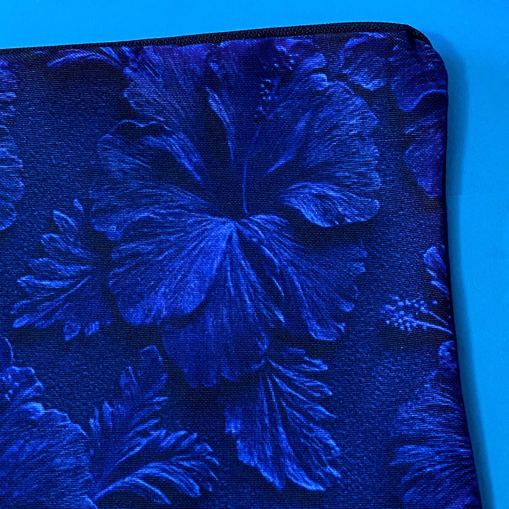 very dark inky blue canvas zip pouch with floral hibiscus deep design on both sides. Midnight botanical design with leaves and petals. floral gifts uk.