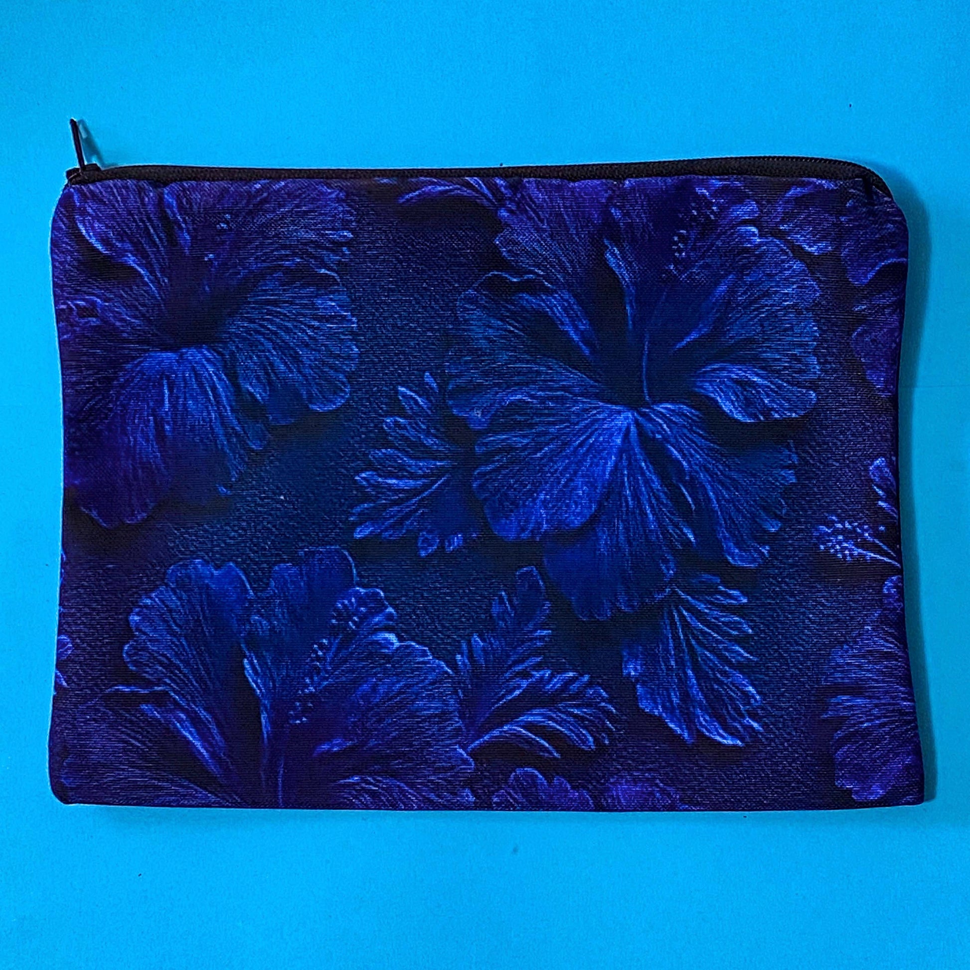 very dark inky blue canvas zip pouch with floral hibiscus deep design on both sides. Midnight botanical design with leaves and petals. floral gifts uk.