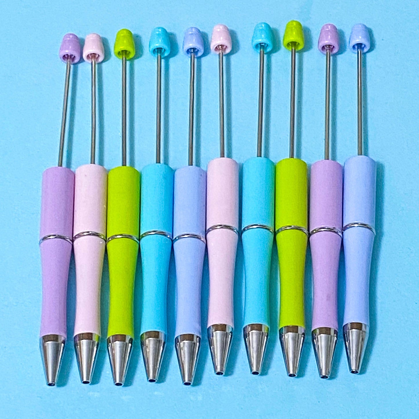 pastel coloured pen blanks on a blue bacground