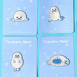 four embroidered fabric iron on seal applique  patches on a blue background
