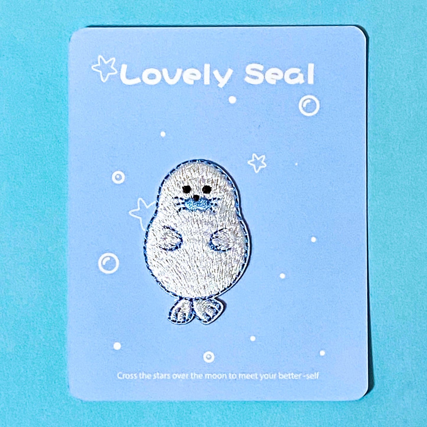 iron on applique embroidered patch of a cute seal on a blue background