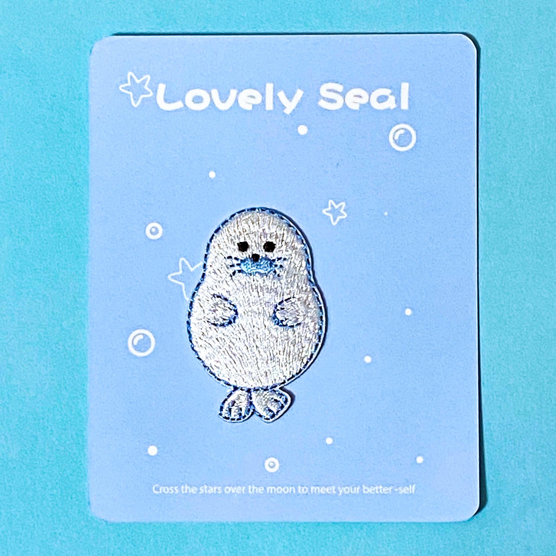 iron on applique embroidered patch of a cute seal on a blue background
