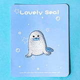 Embroidered patch of a seal on a blue card with 'Lovely Seal' text.