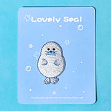 iron on applique embroidered patch of a cute seal on a blue background