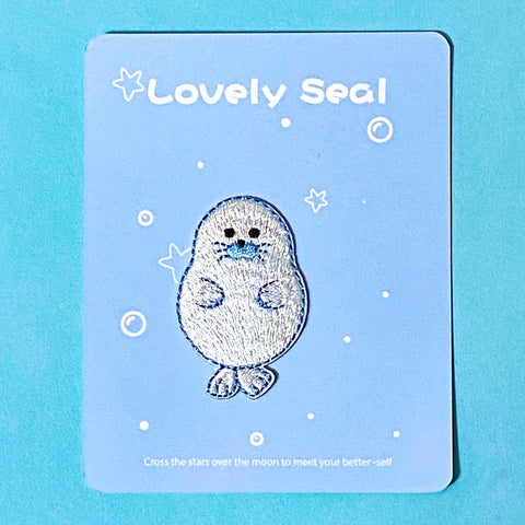 iron on applique embroidered patch of a cute seal on a blue background