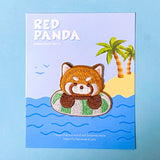 Embroidery patch of a red panda on a card with palm trees and water