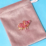 pink pig small rhinestone brooch on a pink velvet bag