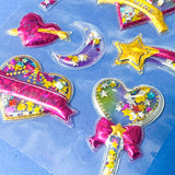 very large pack of 3d shaker puffy clear stickers with moving sequins and bright pink magical motifs