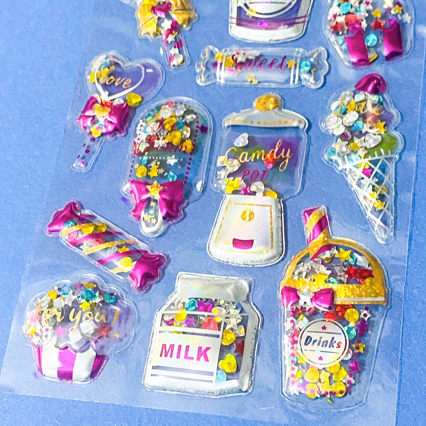 very large pack of 3d shaker puffy clear stickers with moving sequins and bright pink magical motifs