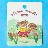 embroidered fabric iron on squirrel patch holding a tulip on a blue background