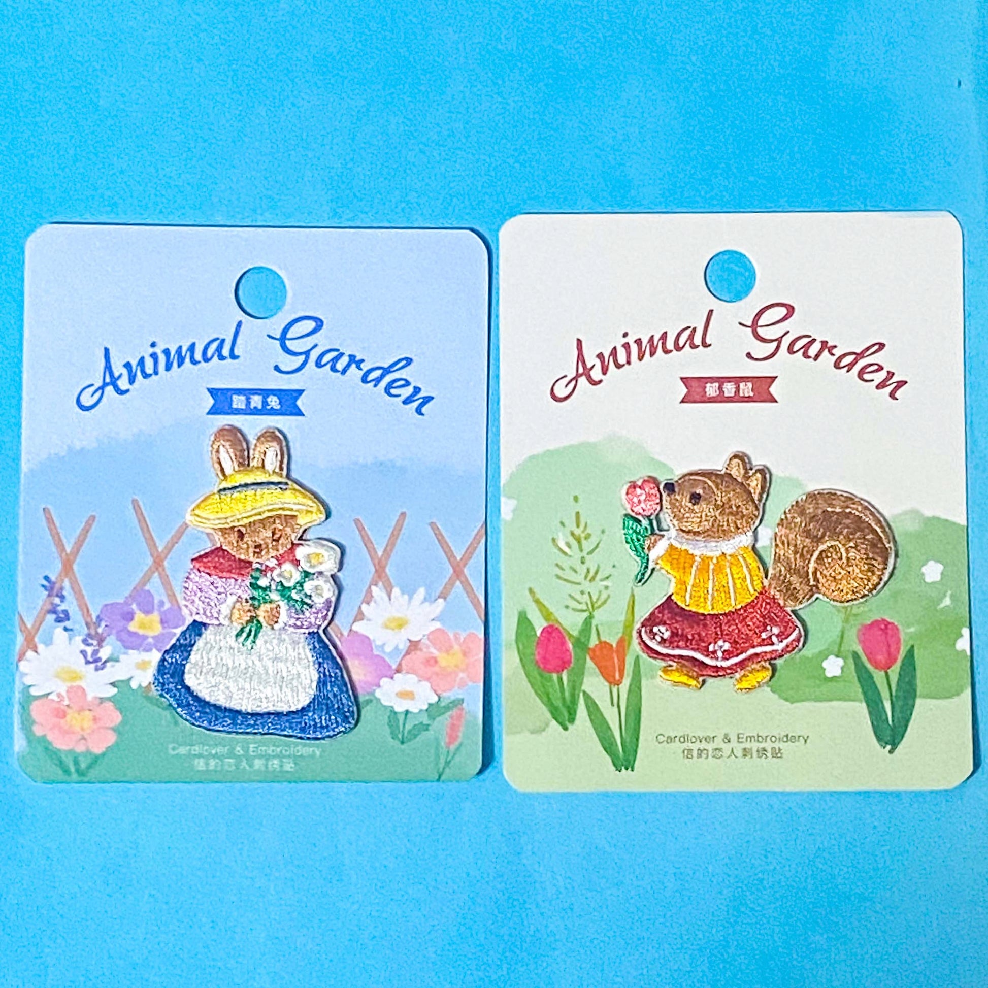 storybook cute woodland embroidered iron on fabric appliques of rabbit and squirrel on a blue background