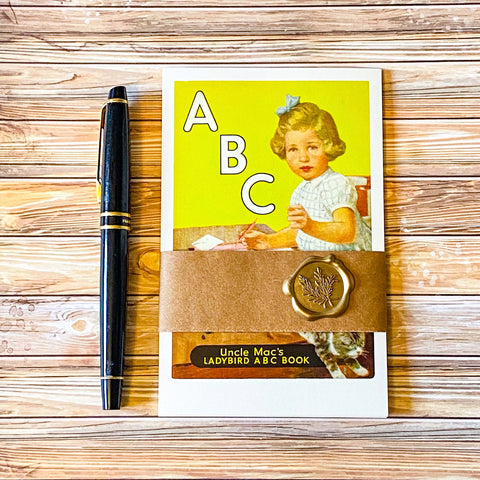 vintage set of 5 ladybird book cover retro postcards with a kraft belly band and wax seal sticker with a fountain pen 