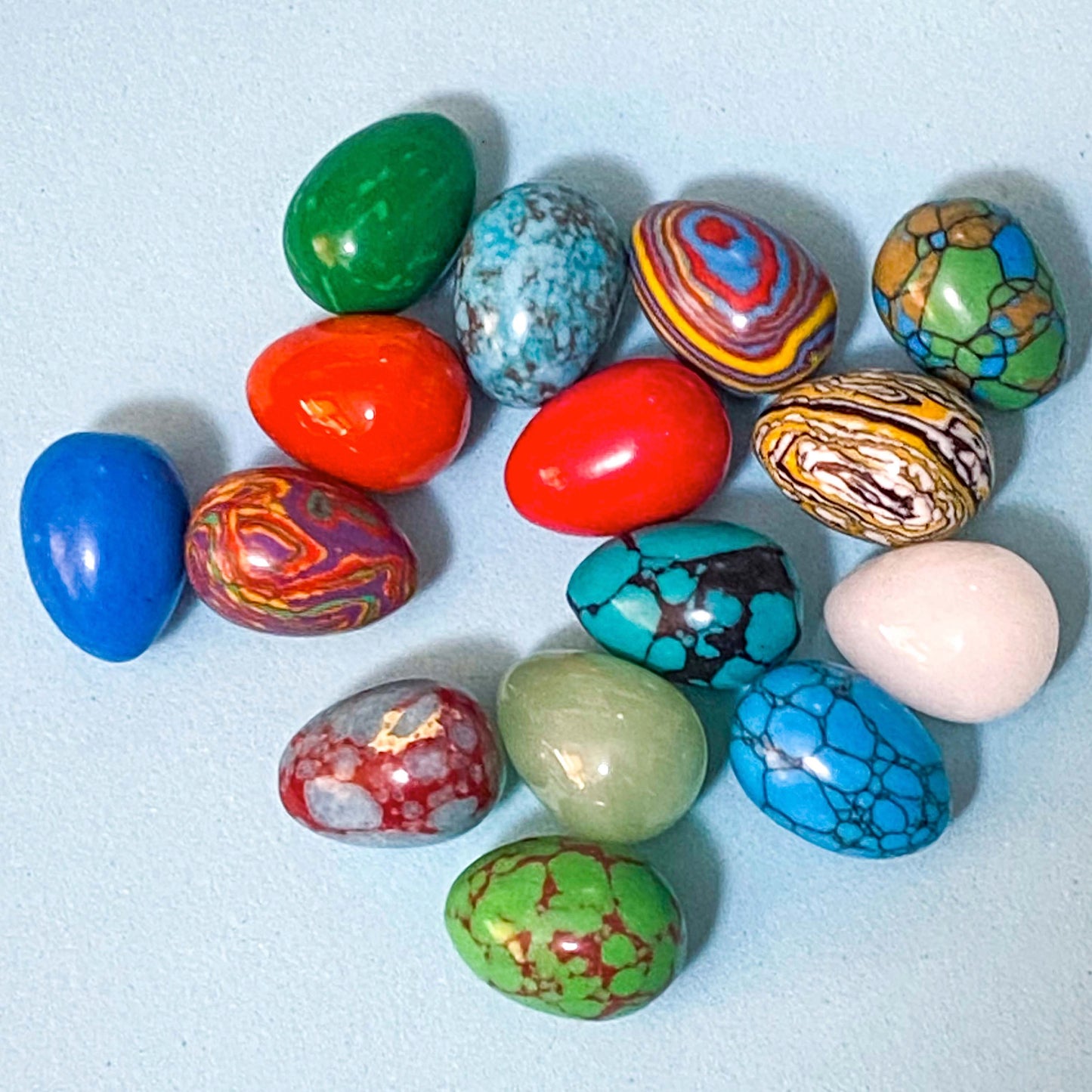 colourful gem stone eggs on a blue background