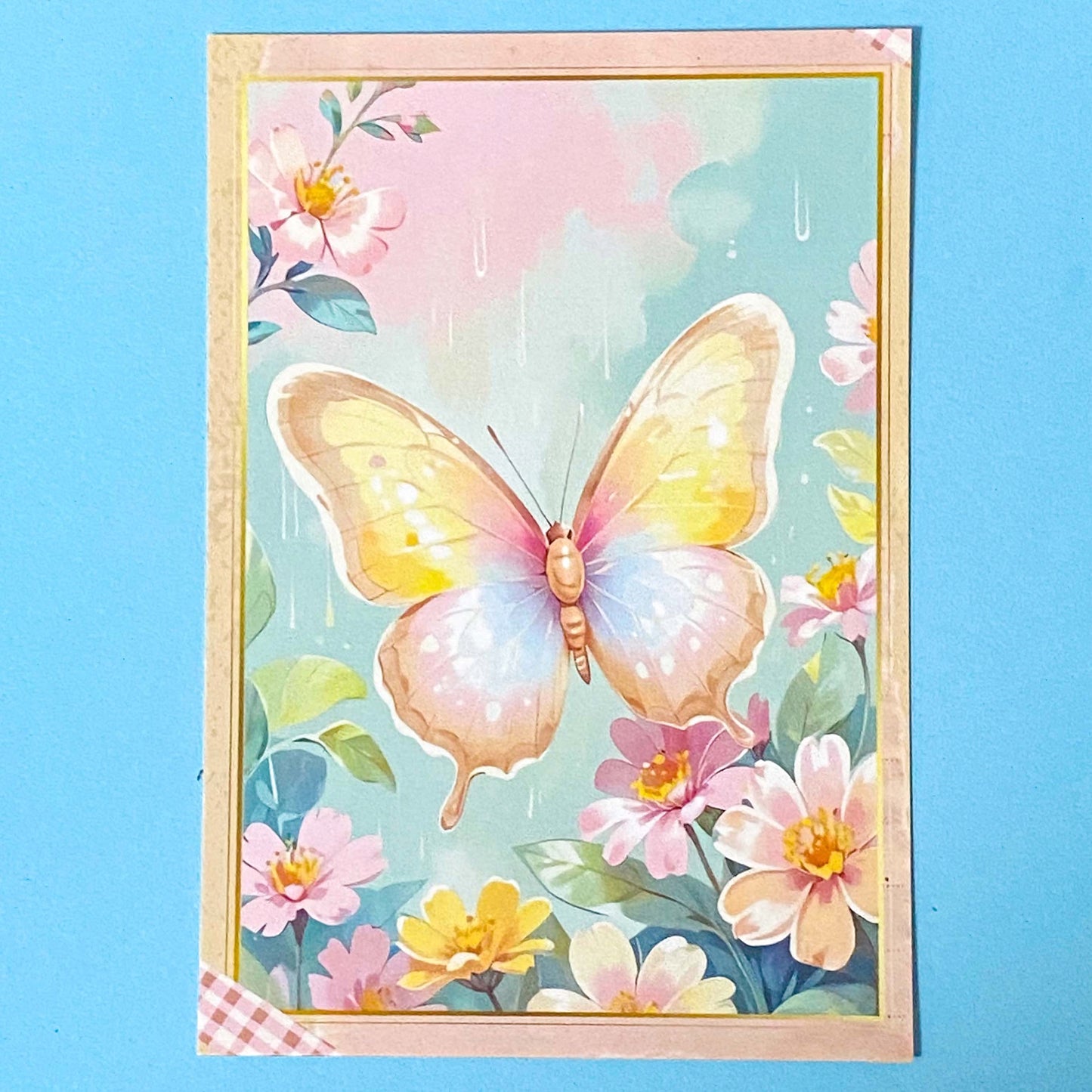 pastel spring postcard of a colourful butterfly and flowers on a blue background