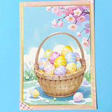 Easter-themed decorative postcard with a basket of colourful eggs and cherry blossoms on a blue background.