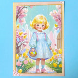 spring postcard of a vintage style  girl with a basket in a floral setting on a blue background