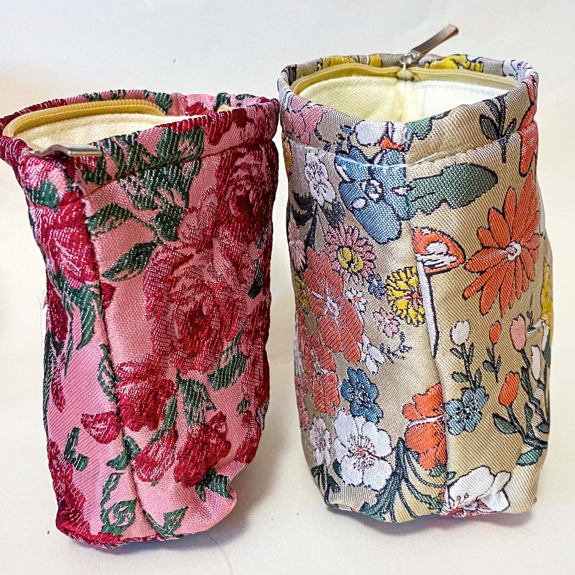 premium woven rose arbour floral bucket shaped small cosmetic pouch with crimson roses on a pink background with cream lining and concealed zip. Uk letterbox flower gifts shop.