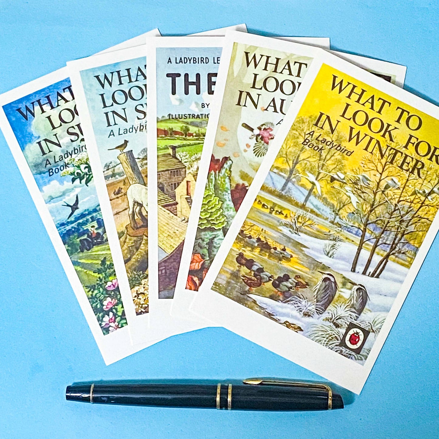 five ladybird book cover postcards showing what to look for in spring, summer, autumn and winter