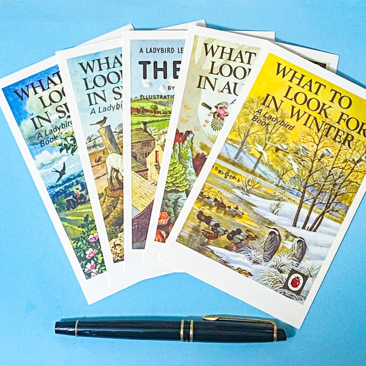 five ladybird book cover postcards showing what to look for in spring, summer, autumn and winter