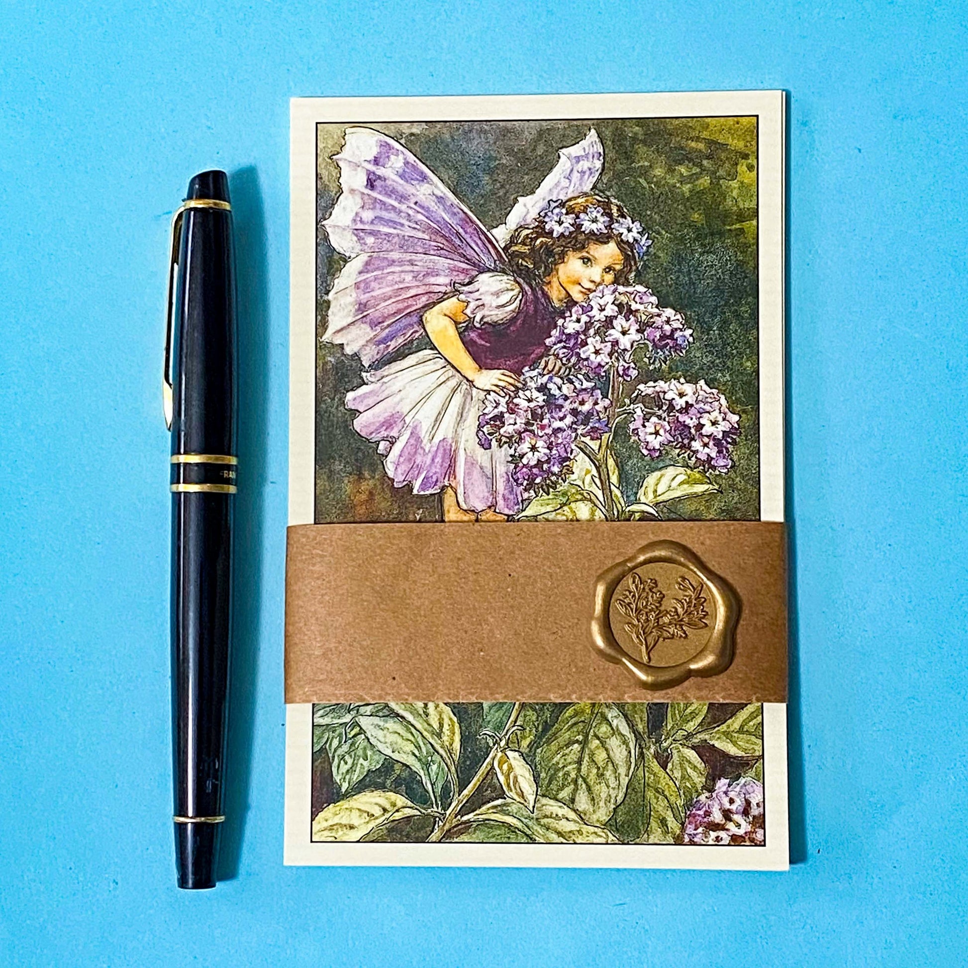vintage flower fairy postcards set wrapped in a kraft belly band with wax sticker featuring heliotrope fairies on a blue background