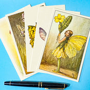 vintage botanical flower fairy postcards showing spring meadow fairies on blue background