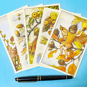 flower fairy vintage postcards featuring apple, acorn, hazelnut, beech and larch fairies on a blue background