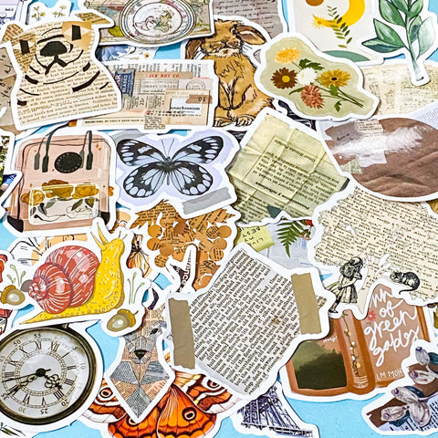 vintage laptop sticker set with camera, violin, dog, newspapers, letters, flowers and moths