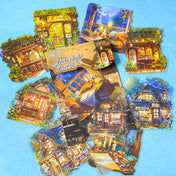 hidden worlds amberlight tavern cosy fantasy large plastic stickers set with candlelit rooms, woodland cottages and warm glowing tavern scenes