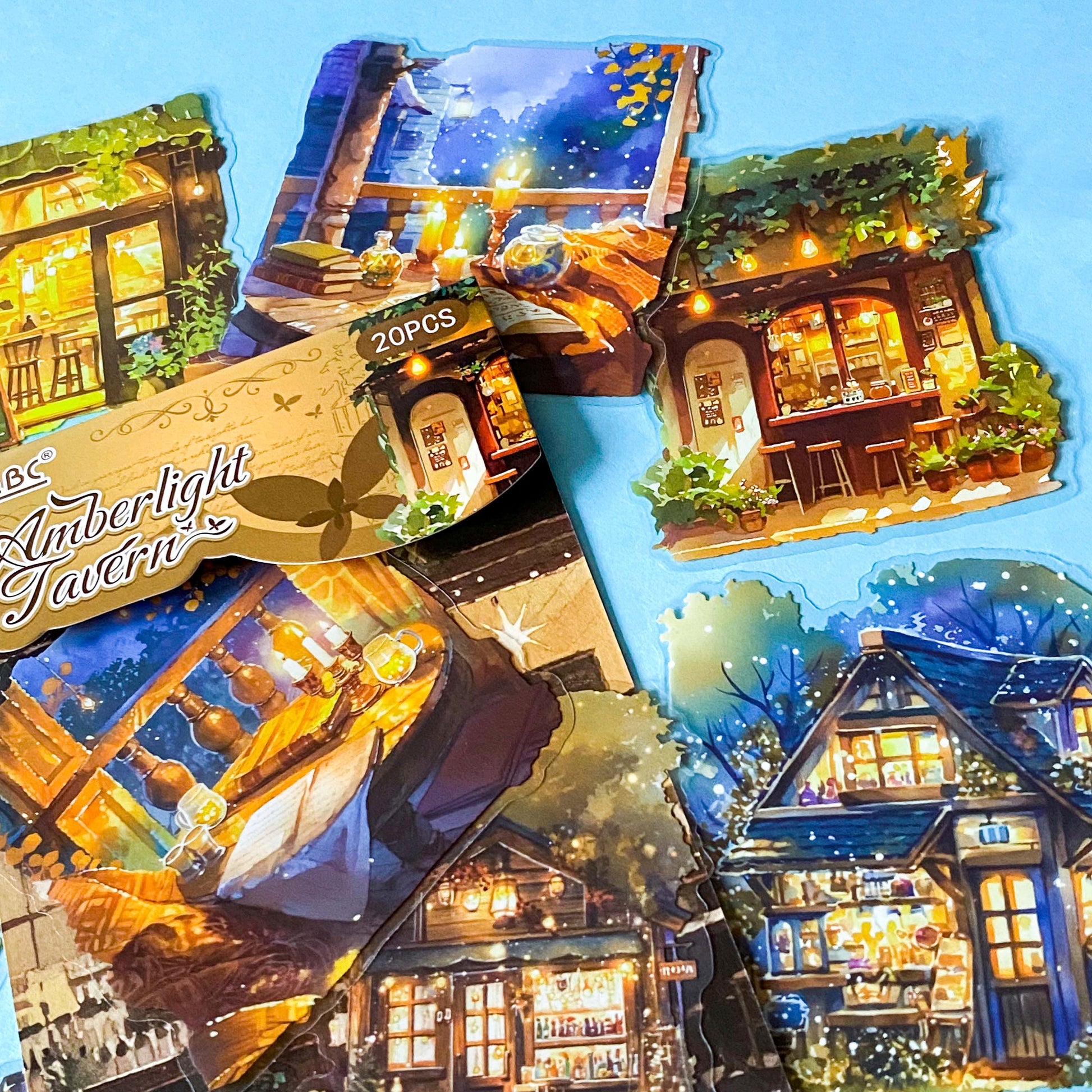 hidden worlds amberlight tavern cosy fantasy large plastic stickers set with candlelit rooms, woodland cottages and warm glowing tavern scenes