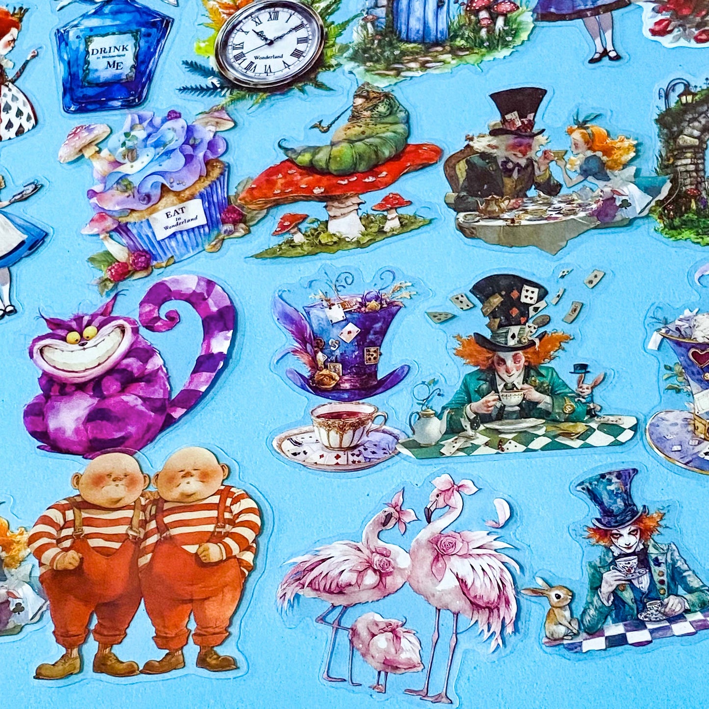 magical alice in wonderland pack of 40 large clear PET stickers with colourful characters including cheshire cat, mad hatter, flamingoes, caterpillar and rabbit on a bright turquoise background