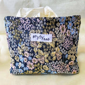 beautiful woven floral tapestry pouch with cream lining, concealed zip- finish and gusseted base. English garden at twilight themed pattern with daffodils, foxgloves, blue pink and yellow flowers. Perfect for cosmetics, stationery and everyday essentials.