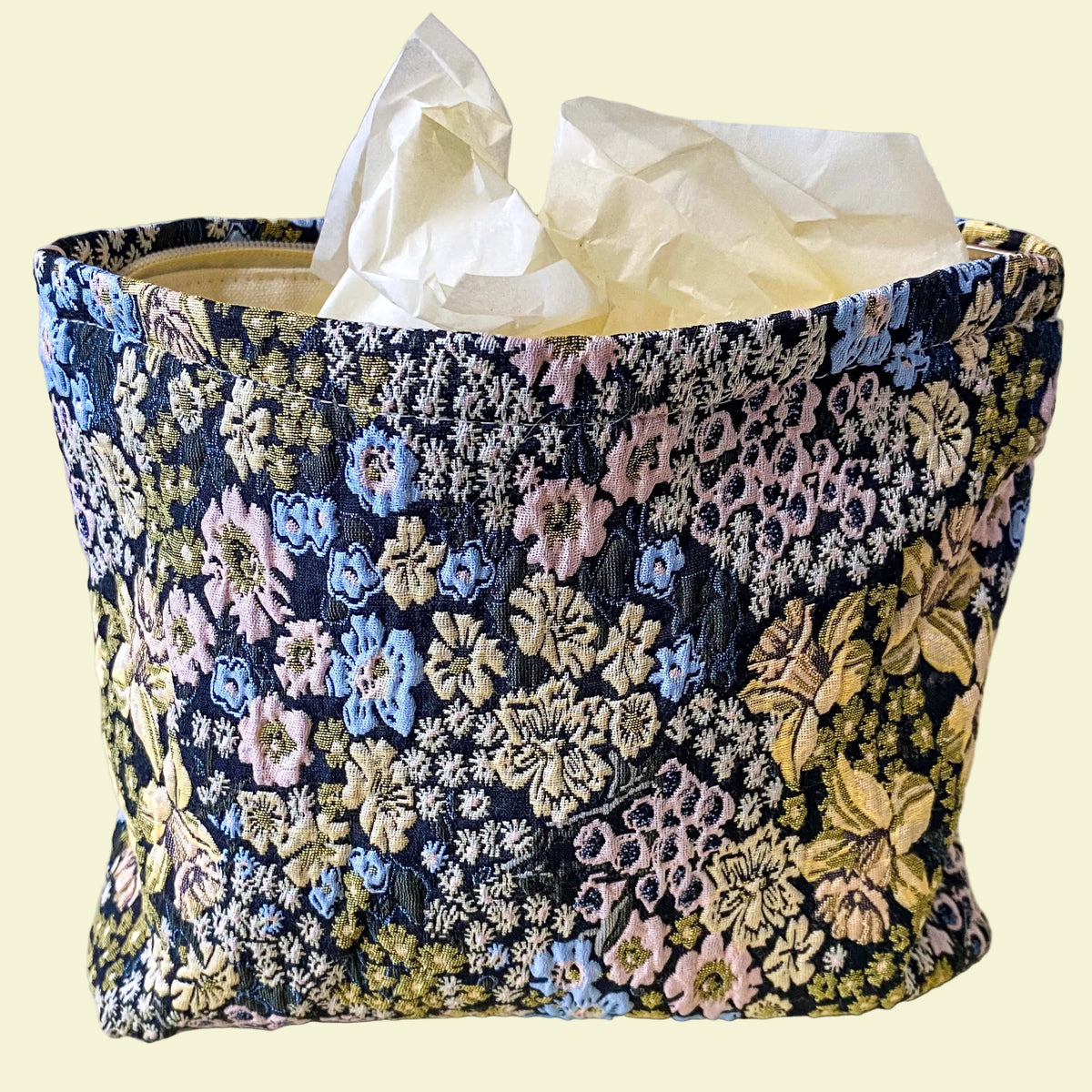 beautiful woven floral tapestry pouch with cream lining, concealed zip- finish and gusseted base. English garden at twilight themed pattern with daffodils, foxgloves, blue pink and yellow flowers. Perfect for cosmetics, stationery and everyday essentials.
