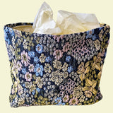 beautiful woven floral tapestry pouch with cream lining, concealed zip- finish and gusseted base. English garden at twilight themed pattern with daffodils, foxgloves, blue pink and yellow flowers. Perfect for cosmetics, stationery and everyday essentials.