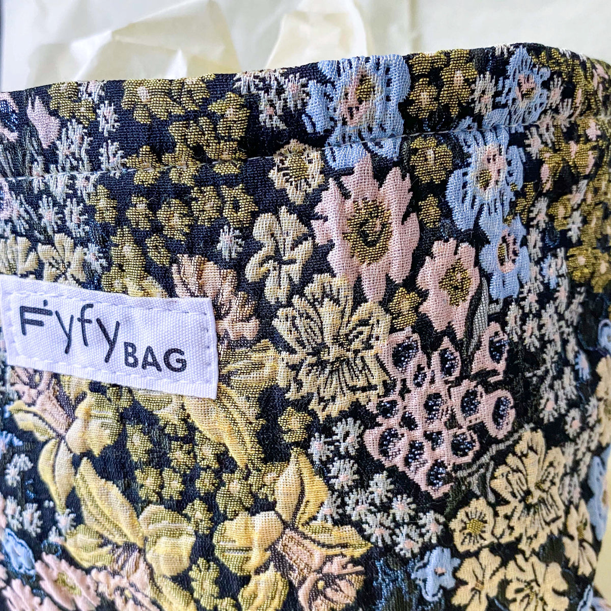 beautiful woven floral tapestry pouch with cream lining, concealed zip- finish and gusseted base. English garden at twilight themed pattern with daffodils, foxgloves, blue pink and yellow flowers. Perfect for cosmetics, stationery and everyday essentials.