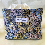 beautiful woven floral tapestry pouch with cream lining, concealed zip- finish and gusseted base. English garden at twilight themed pattern with daffodils, foxgloves, blue pink and yellow flowers. Perfect for cosmetics, stationery and everyday essentials.