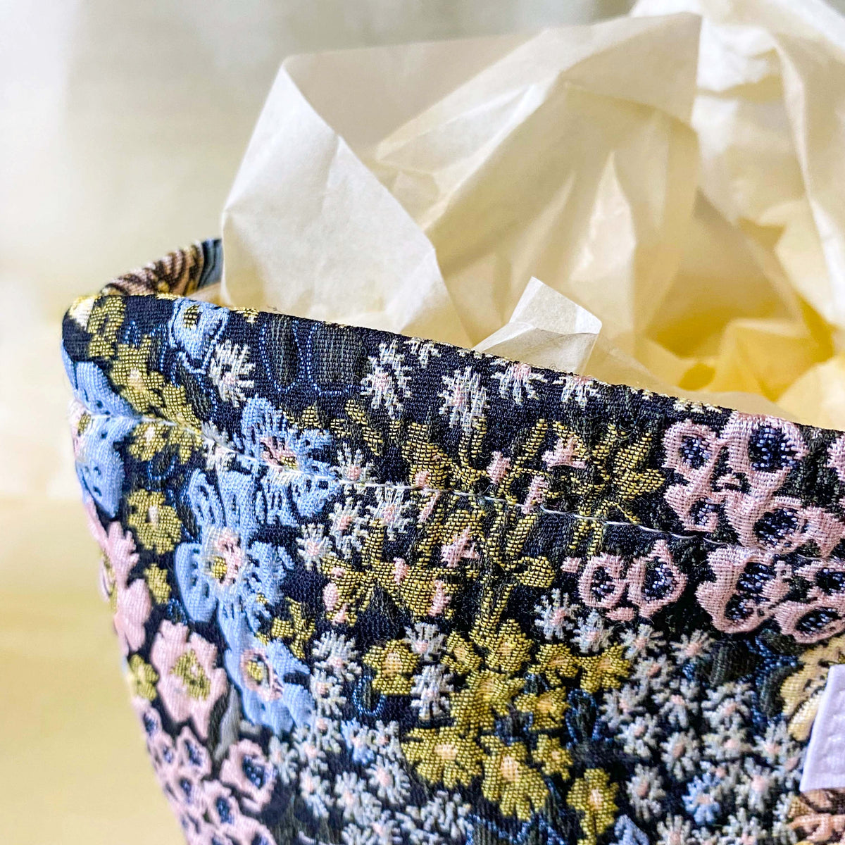 beautiful woven floral tapestry pouch with cream lining, concealed zip- finish and gusseted base. English garden at twilight themed pattern with daffodils, foxgloves, blue pink and yellow flowers. Perfect for cosmetics, stationery and everyday essentials.
