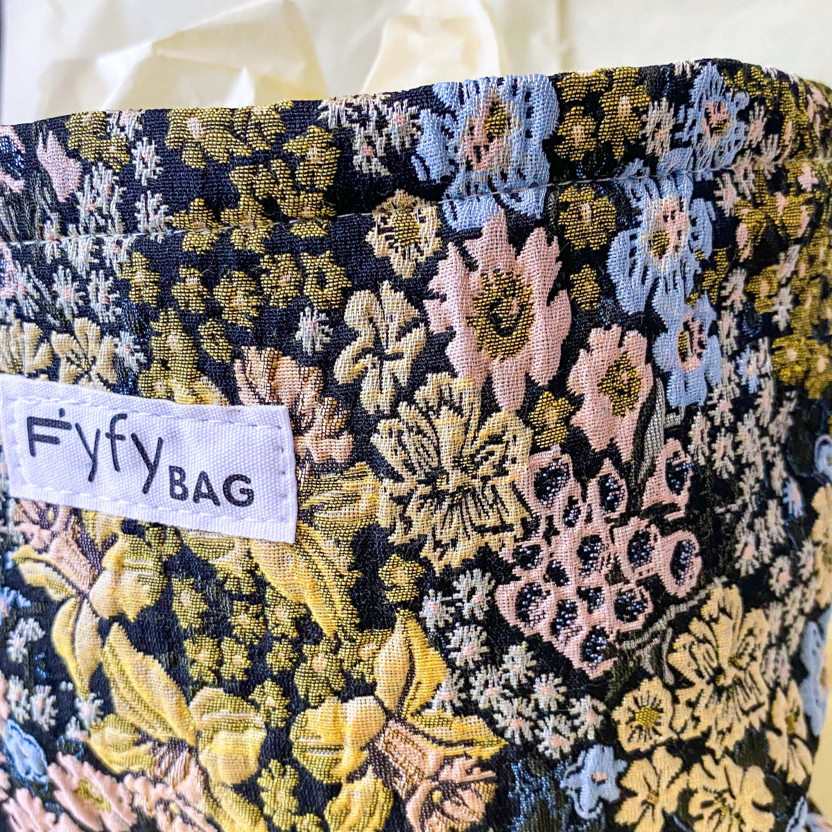 beautiful woven floral tapestry pouch with cream lining, concealed zip- finish and gusseted base. English garden at twilight themed pattern with daffodils, foxgloves, blue pink and yellow flowers. Perfect for cosmetics, stationery and everyday essentials.