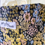 beautiful woven floral tapestry pouch with cream lining, concealed zip- finish and gusseted base. English garden at twilight themed pattern with daffodils, foxgloves, blue pink and yellow flowers. Perfect for cosmetics, stationery and everyday essentials.