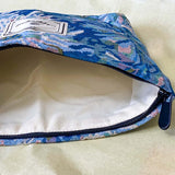 blue, pale pink and turquoise chrysanthemum tapestry pouch with woven floral fabric, cream lining, concealed zip closure and gusseted base. Botanical make up cosmetic pouch, large pencil case or journaling bag. Uk gifts shop. Gifts for flower lovers.