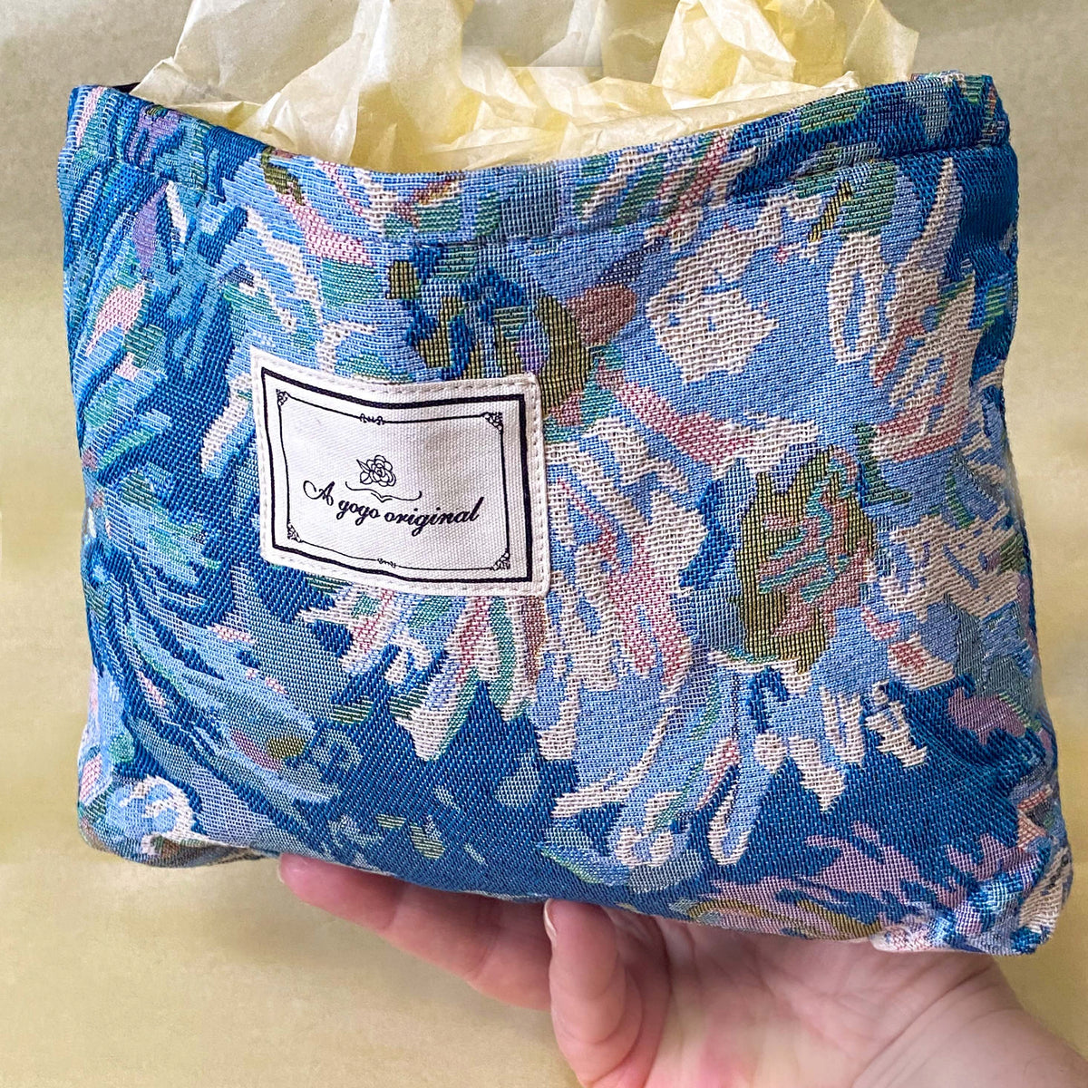 blue, pale pink and turquoise chrysanthemum tapestry pouch with woven floral fabric, cream lining, concealed zip closure and gusseted base. Botanical make up cosmetic pouch, large pencil case or journaling bag. Uk gifts shop. Gifts for flower lovers.