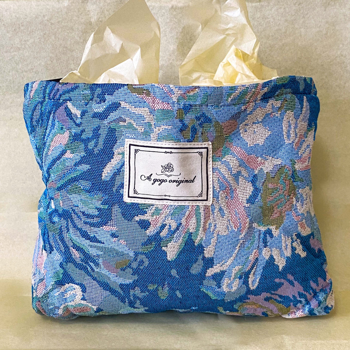 blue, pale pink and turquoise chrysanthemum tapestry pouch with woven floral fabric, cream lining, concealed zip closure and gusseted base. Botanical make up cosmetic pouch, large pencil case or journaling bag. Uk gifts shop. Gifts for flower lovers.
