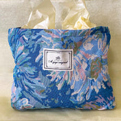 blue, pale pink and turquoise chrysanthemum tapestry pouch with woven floral fabric, cream lining, concealed zip closure and gusseted base. Botanical make up cosmetic pouch, large pencil case or journaling bag. Uk gifts shop. Gifts for flower lovers.